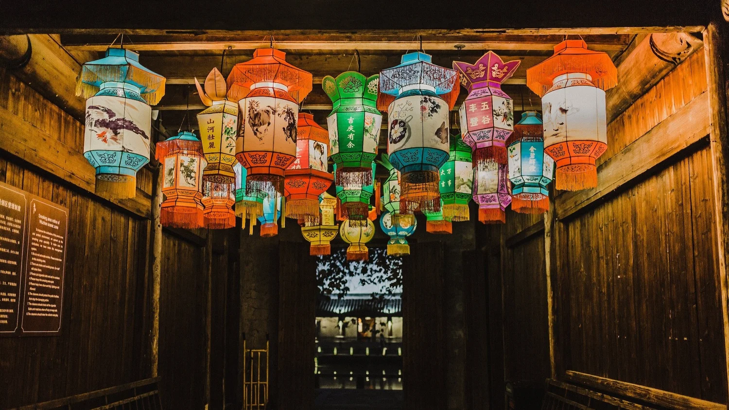 Colourful paper lanterns hanging inside a wooden market hall